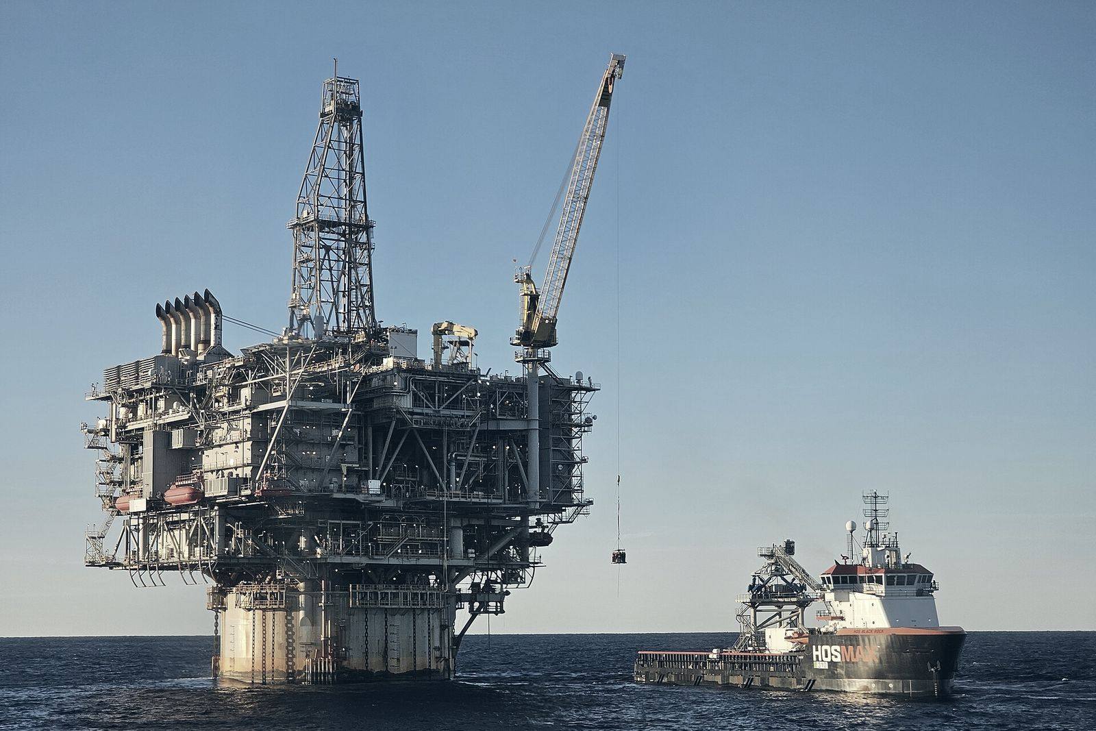 An offshore platform with a support vessel working alongside