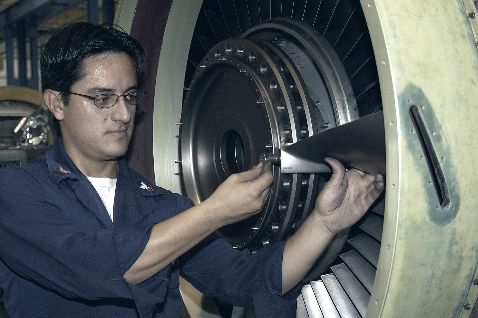 Technician working inside an aircraft engine